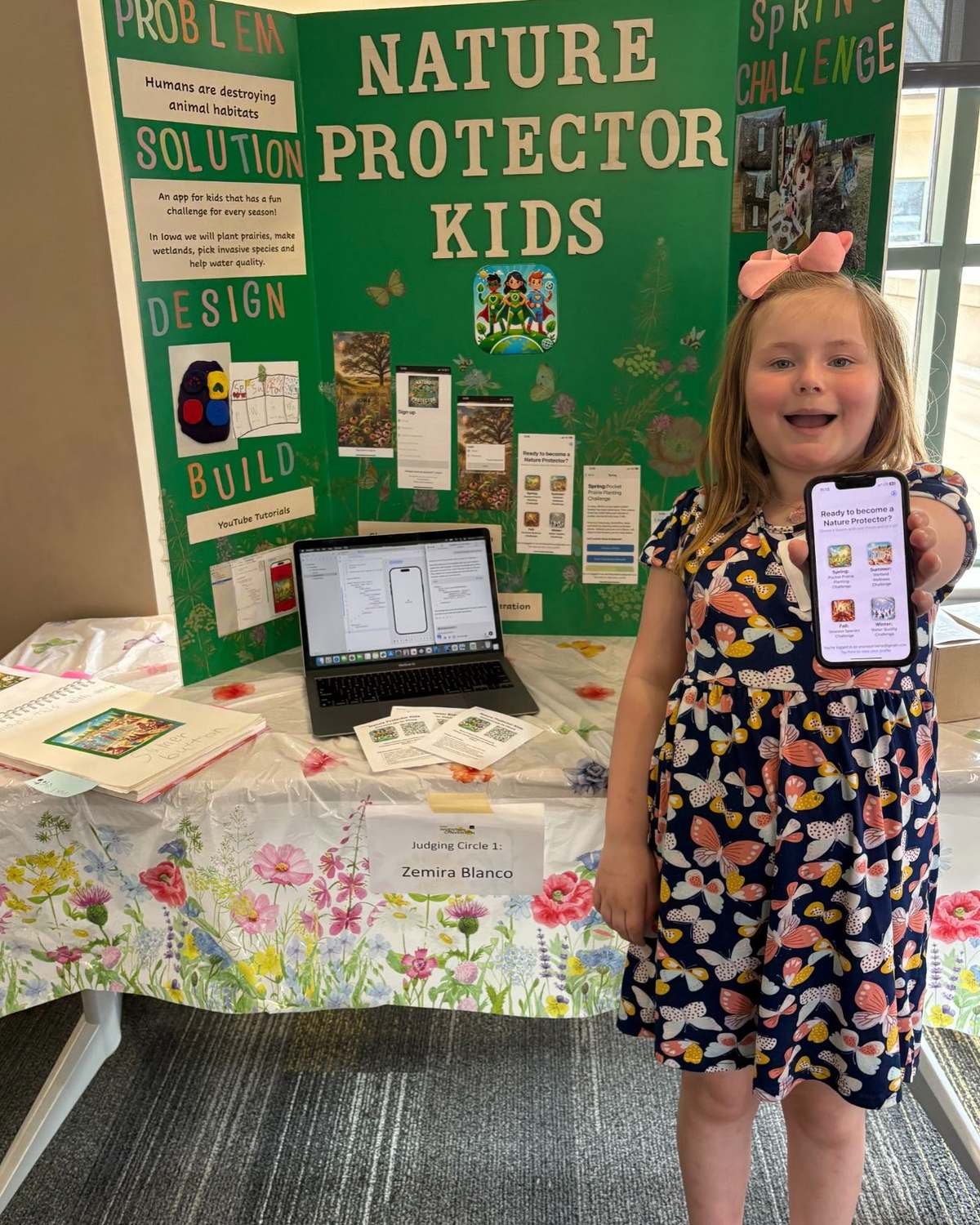 A Design Your World student presenting her science fair display board and project findings