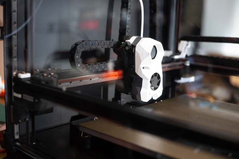 A 3D printer nozzle laying down filament layer by layer