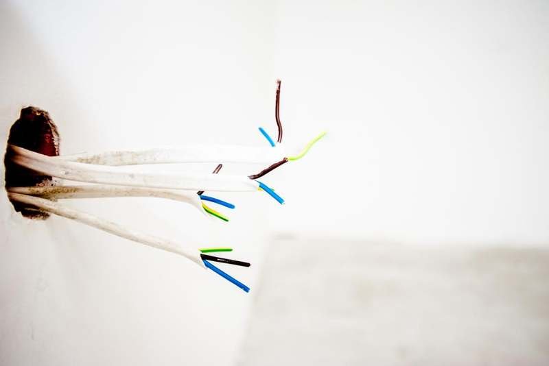 Coloured jumper wires with exposed ends, used to connect a microcontroller to servos
