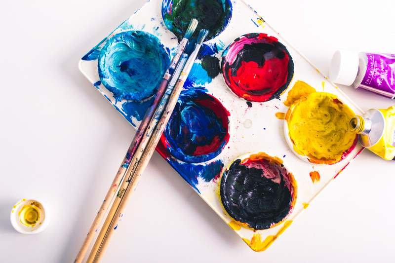 A paint palette and brushes, the art in science technology engineering art and maths