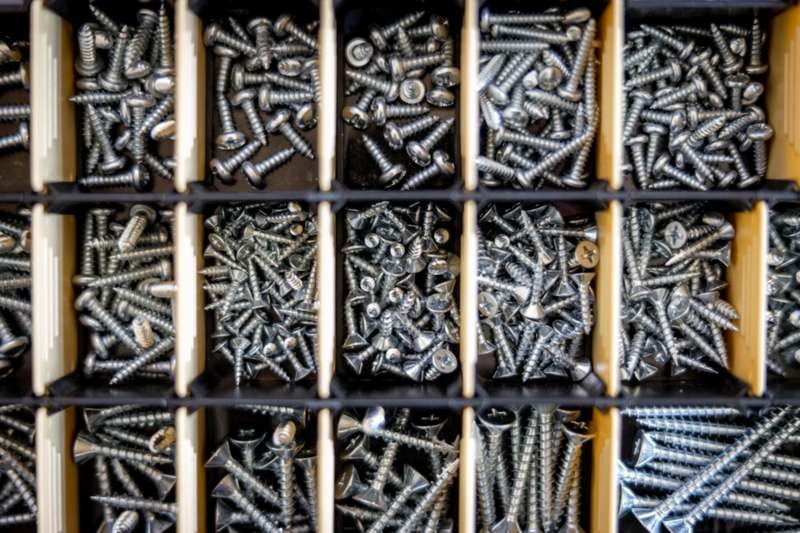 Components sorted into compartments on a workshop bench
